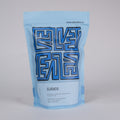 Blue coffee bag with 'Cafe Velvet' branding on a light gray background